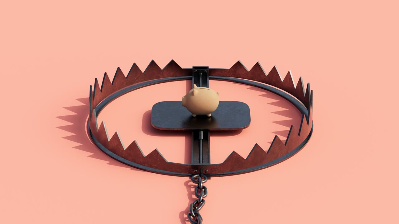 Illustration of a piggy bank placed on the trigger of an open bear trap, set against a solid pink background.
