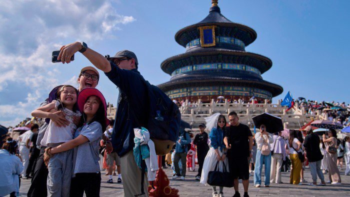 A family take a selfie at the Temple of Heaven in Beijing