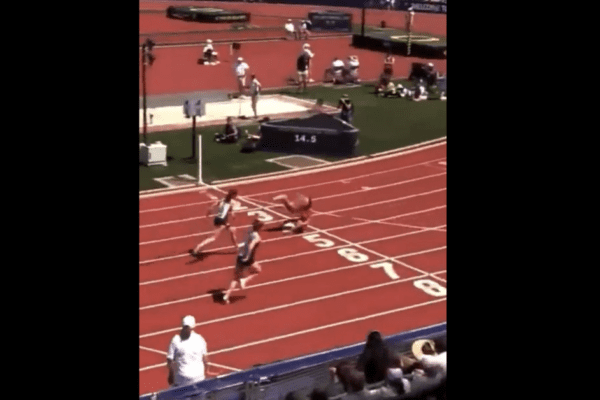 High school hurdler rolls across finish line after losing her balance High school hurdler rolls across finish line after losing her balance