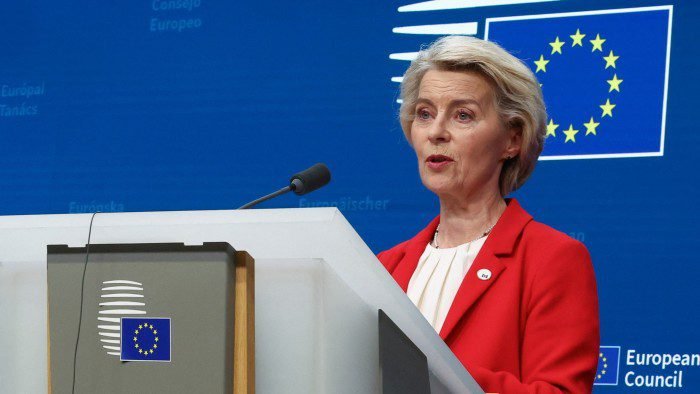 Ursula von der Leyen speaks at a lectern with an EU flag behind her